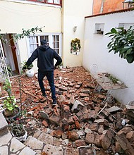 A man walks over debris in Zagreb, the Croatian capital.
Credit:	Antonio Bronic/Reuters