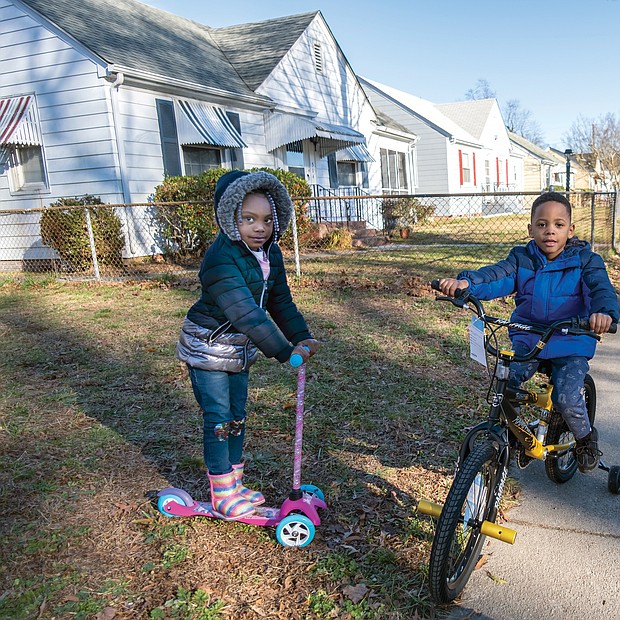 Gani brown, 4, and her older brother, Thi’yon Everhart, 5, try out their new wheels the day after Christmas near their grandmother’s house in the 500 block of Milton Avenue in North Side. More good weather for outdoor activities is expected before and after New Year’s Day, with temperatures expected to climb into the 60s on Saturday after rain showers on Jan. 1.
