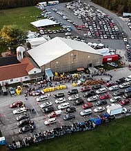 Hundreds of cars line up in orderly rows to received free food from the Chesterfield Food bank’s drive-thru operation on Iron bridge Road in Chester. Officials have seen the need for help skyrocket during the pandemic with more and more people out of work.