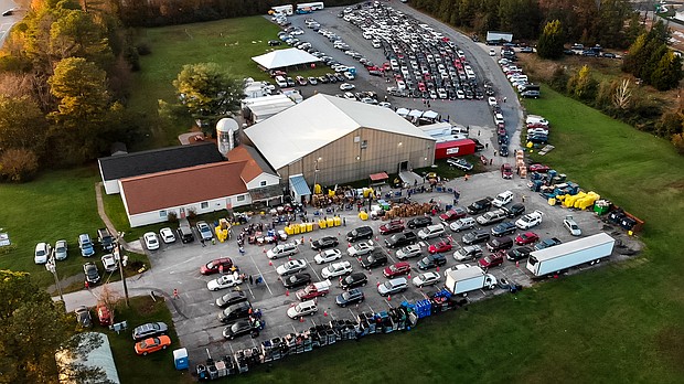 Hundreds of cars line up in orderly rows to received free food from the Chesterfield Food bank’s drive-thru operation on Iron bridge Road in Chester. Officials have seen the need for help skyrocket during the pandemic with more and more people out of work.