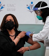 Vice President-elect Kamala Harris receives the Moderna COVID-19 vaccine from Patricia Cummings on Tuesday. She and her husband, Doug Emhoff, were vaccinated at United Medical Center in Southeast Washington. It is the only public hospital in Washington and offers community-based services to area residents who are mostly African-American and have lower incomes than the rest of D.C.