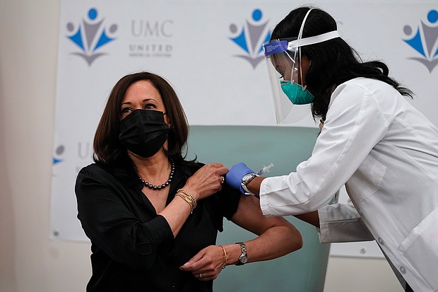 Vice President-elect Kamala Harris receives the Moderna COVID-19 vaccine from Patricia Cummings on Tuesday. She and her husband, Doug Emhoff, were vaccinated at United Medical Center in Southeast Washington. It is the only public hospital in Washington and offers community-based services to area residents who are mostly African-American and have lower incomes than the rest of D.C.