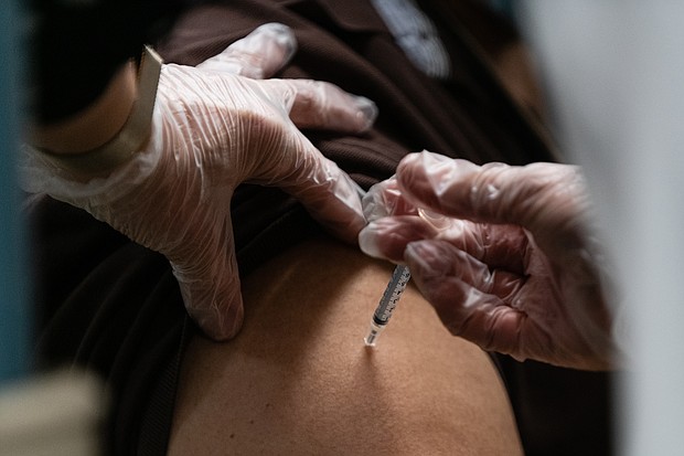 A pharmacist administers a dose of the Pfizer-BioNTech Covid-19 vaccine to a nursing home resident in the Bronx borough of New York on December 21, 2020.
Credit:	Eric Lee/Bloomberg/Getty Images