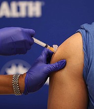 An EU drug regulator recommends authorization of the Moderna Covid-19 vaccine. Seen here, Leonida Lipshy, RN in the Covid unit at the Broward Health Medical Center, gives Dr. Nadav Fields, DO., internal medicine, Broward Health Imperial Point, a shot of the Moderna Covid-19 vaccine on December 23, 2020 in Fort Lauderdale, Florida.
Credit:	Joe Raedle/Getty Images