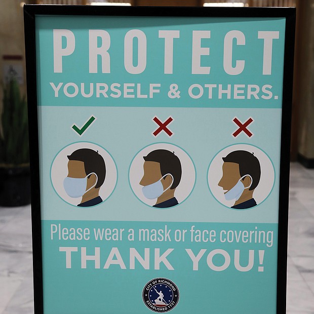 City Hall is being proactive in pushing safe practices during the pandemic. This sign was prominently displayed outside the second floor City Council Chambers on Monday before the nine council members were sworn in — including seven women, the most ever. Only a few people, mostly media and some family members, were allowed in the chamber for the ceremony. Others were able to connect to online channels to see the public ceremony.