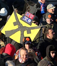 Thousands of people — many carrying high-powered weapons and waving or wearing Confederate symbols — flood Downtown for a gun rights rally at the State Capitol on the Martin Luther King Jr. Holiday as the General Assembly considers gun control measures.