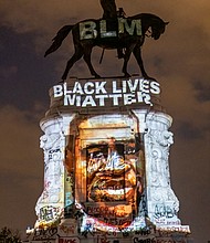 A Black Lives Matter tribute to the late George Floyd is projected onto the statue of Confederate Gen. Robert E. Lee on the evening of June 6 by local artist Dustin Klein, a striking signal of change. The statue and grounds on Monument Avenue became a central point for demonstrators and others seeking a metamorphosis in the city.