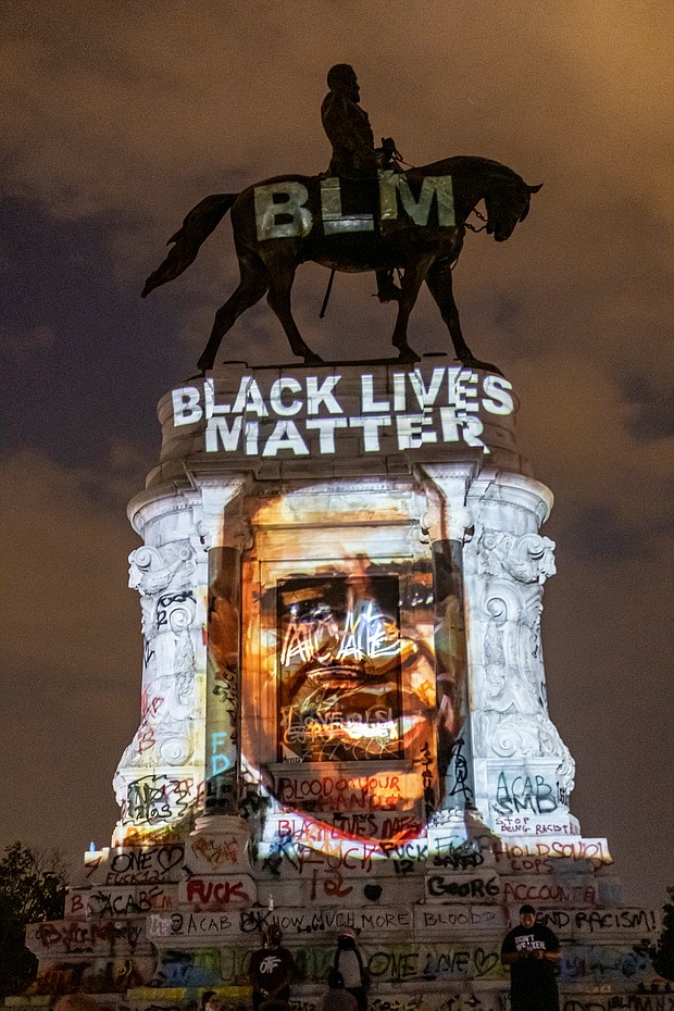 A Black Lives Matter tribute to the late George Floyd is projected onto the statue of Confederate Gen. Robert E. Lee on the evening of June 6 by local artist Dustin Klein, a striking signal of change. The statue and grounds on Monument Avenue became a central point for demonstrators and others seeking a metamorphosis in the city.