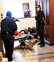 U.S. Capitol Police hold protesters at gunpoint near the House Chamber inside the Capitol. The Trump mob broke windows and forced their way into the building, which went on lockdown.