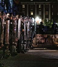 A protester confronts Virginia State Police troopers, who declared an unlawful assembly before pepper-spraying peaceful protesters and bystanders on June 26.