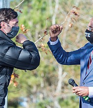 Jon Ossoff, left, and Raphael Warnock exchange elbow bumps Monday during a campaign rally in Augusta, Ga. Democrats Ossoff and Warnock won their respective racdes against incumbent Republican Sens. David Perdue and Kelly Loeffler in a runoff election Jan. 5.