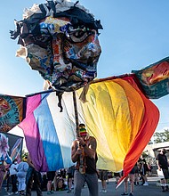 A huge figure representing gay pride becomes a focal point for the Stonewall Rising: LGBTQ March for Black Lives. Hundreds of members of VA Pride, Minority Vets and other partners flooded the streets of North Side to show their alliance with the cause of racial justice.