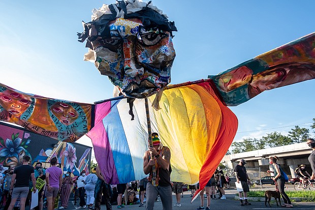 A huge figure representing gay pride becomes a focal point for the Stonewall Rising: LGBTQ March for Black Lives. Hundreds of members of VA Pride, Minority Vets and other partners flooded the streets of North Side to show their alliance with the cause of racial justice.