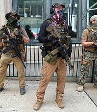 Armed members of private militia groups advocate for gun rights near the State Capitol on Aug. 18 before marching to the Siegel Center on Broad Street where the House of Delegates was meeting during a special General Assembly session to take up police reform, criminal justice reform and budget measures.