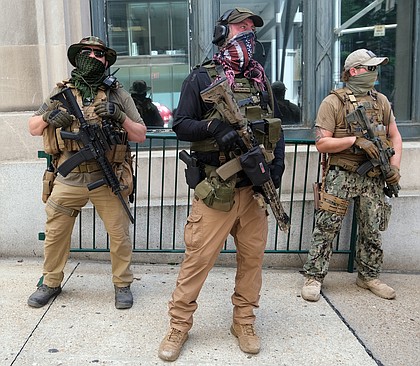 Armed members of private militia groups advocate for gun rights near the State Capitol on Aug. 18 before marching to the Siegel Center on Broad Street where the House of Delegates was meeting during a special General Assembly session to take up police reform, criminal justice reform and budget measures.