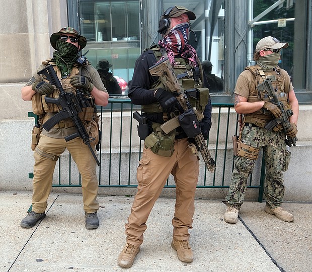 Armed members of private militia groups advocate for gun rights near the State Capitol on Aug. 18 before marching to the Siegel Center on Broad Street where the House of Delegates was meeting during a special General Assembly session to take up police reform, criminal justice reform and budget measures.