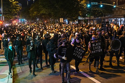 About 1,000 protesters march through Richmond to show solidarity with demonstrators in Portland, Ore., where federal officials used questionable force to detain or arrest people.