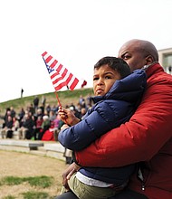 Antoine Ransom and his 4-year-old son, Mason, attend the Feb. 29 dedication of the expansion of the Shrine of Memory and grand opening of the C. Kenneth Wright Pavilion at the Virginia War Memorial in Downtown that pays tribute to Virginians who died in various wars. Mr. Ransom’s cousin, Air Force Maj. Charles A. Ransom of Midlothian, was killed in Kabul, Afghanistan, during Operation Enduring Freedom in 2011.