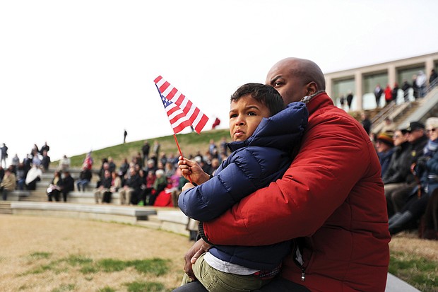 Antoine Ransom and his 4-year-old son, Mason, attend the Feb. 29 dedication of the expansion of the Shrine of Memory and grand opening of the C. Kenneth Wright Pavilion at the Virginia War Memorial in Downtown that pays tribute to Virginians who died in various wars. Mr. Ransom’s cousin, Air Force Maj. Charles A. Ransom of Midlothian, was killed in Kabul, Afghanistan, during Operation Enduring Freedom in 2011.
