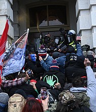 Trump supporters clash with police and security forces as they storm the Capitol in Washington, DC on January 6, 2021.
Credit:	Brendan Smialowski/AFP/Getty Images