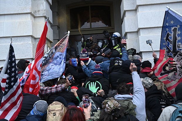 Trump supporters clash with police and security forces as they storm the Capitol in Washington, DC on January 6, 2021.
Credit:	Brendan Smialowski/AFP/Getty Images