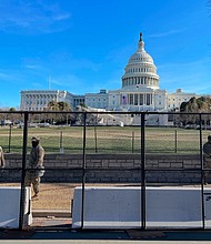 US National Guard soldiers guard the grounds of the US Capitol from behind a security fence in Washington, DC, on January 9, 2021.
Credit:	Daniel Slim/AFP/Getty Images