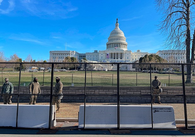 US National Guard soldiers guard the grounds of the US Capitol from behind a security fence in Washington, DC, on January 9, 2021.
Credit:	Daniel Slim/AFP/Getty Images