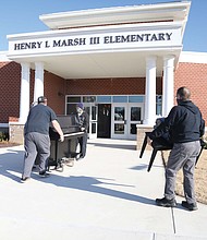 A crew from Famous Jerry Piano Moving in Disputanta moves a new Yamaha piano into Henry L. Marsh III Elementary School on Tuesday under the watchful and excited guidance of Principal Kimberly Cook.