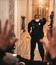 U.S. Capitol Police Officer Eugene Goodman single-handedly holds off insurrectionists, keeping them from entering the U.S. Senate from a section of the U.S. Capitol on Jan. 6.