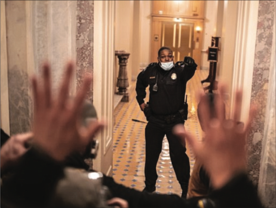 U.S. Capitol Police Officer Eugene Goodman single-handedly holds off insurrectionists, keeping them from entering the U.S. Senate from a section of the U.S. Capitol on Jan. 6.