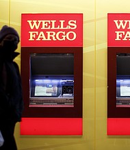 Wells Fargo can't seem to escape its troubled past. Pedestrians wearing protective masks walk past automated teller machines at a Wells Fargo bank branch at night in Washington, DC, on January 7.
Credit:	Ting Shen/Bloomberg/Getty Images
Dateline:	Washington, DC, United States