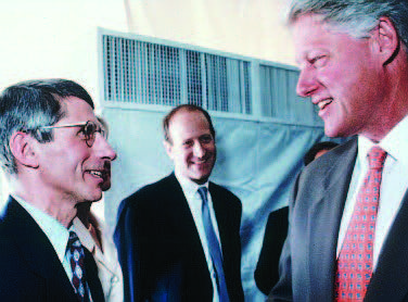 Dr. Anthony Fauci (left) was appointed director of NIAID in 1984 and has served under six presidents. In this photo, President Bill Clinton (right) visits the National Institutes of Health in 1995 and hears about the latest advances in HIV/AIDS research from Fauci.