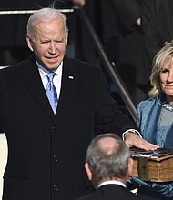 Joe Biden is sworn in as the 46th president of the United States by Chief Justice John Roberts as Jill Biden holds the Bible during the 59th Presidential Inauguration at the US Capitol in Washington, DC, on January 20.
Credit: Saul Loeb/AP