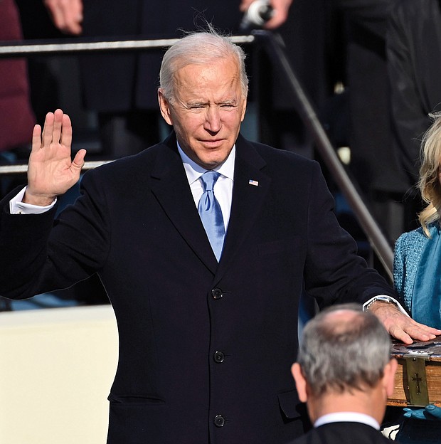 Joseph R. Biden Jr. is sworn in as the 46th president of the United States by U.S. Supreme Court Chief Justice John Roberts as his wife, Jill Biden, holds a Bible that has been in the family since the 1800s.