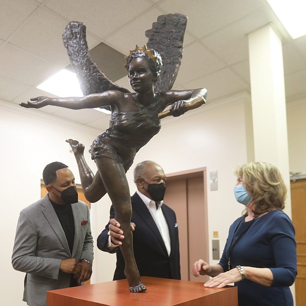 Dr. Derik E. Jones, left, and Dr. Dwight C. Jones, pastors of First Baptist Church of South Richmond, get a closer look at the new bronze sculpture “Hope Empowered by the Truth” with its creator, local artist Kathleen Lowry. The 150-pound sculpture was unveiled at the Decatur Street church on Monday, the Martin Luther King Jr. Holiday, during a ceremony viewed online by more than 200 people. Ms. Lowry donated the piece to the church after attending the socially distanced kickoff last September of First Baptist’s yearlong 200th anniversary celebration. She said the church seemed like the perfect home for the sculpture. “It is recognition of the work you do every day to promote peace in our country,” she said during Monday’s event. “Martin Luther King knew what would be necessary — faith, hopefulness, truth-telling, courage, resilience, kindness and forgiveness. And that is what you are doing and being in the struggle for equality and peace. It is an extremely tall order.” Members of the congregation will be able to see the artwork once the church reopens for in-person worship service. The church has held virtual services because of the pandemic.