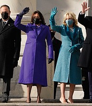 From right, President Joe Biden, his wife Jill Biden, and Vice President Kamala Harris and her husband, Doug Emhoff wave to a small, but cheering crowd as they arrive on the steps of the U.S. Capitol for the start of the official inaugural ceremonies Wednesday.