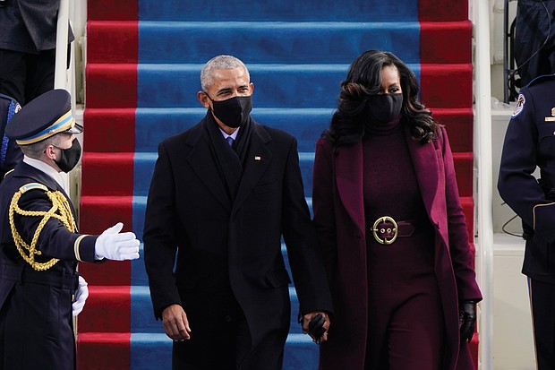 Former President Barack Obama and his wife, former First Lady Michelle Obama, arrive to applause at the U.S. Capitol for the historic swearing in ceremony of Vice President Kamala Harris and President Joe Biden. The nation’s first African-American president took the oath of office from the same spot at the West Front of the Capitol on Jan. 20, 2009, and again on Jan. 21, 2013.