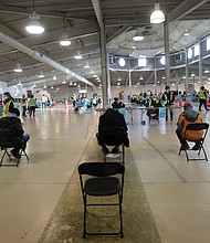 The cavernous Old Dominion Building at Richmond Raceway offers enough space
for vaccination stations to be socially distanced and for people to wait safely for 15 minutes after being inoculated to ensure they do not have an adverse reaction. More than 1,000 people were inoculated against COVID-19 there on Tuesday.