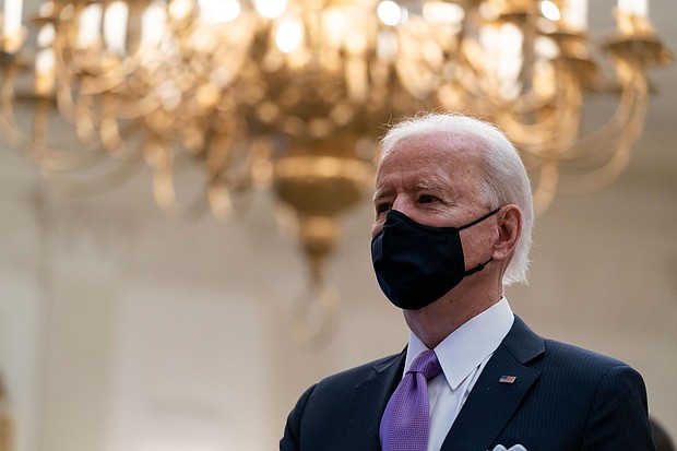 President Joe Biden stands during a performance of the national anthem, during a virtual Presidential Inaugural Prayer Service in the State Dinning Room of the White House on January 21, in Washington, DC.
Credit:	Alex Brandon/AP