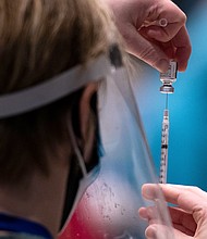 Erin Forsythe
Caption:	Virgina Mason advanced registered nurse practitioner Erin Forsythe loads a syringing with the Pfizer Covid-19 vaccine during a partnership with the hospital network and Amazon to increase the efficiency of vaccinations, at the Amazon Meeting Center in downtown Seattle, Washington on January 24, 2021.
Credit:	Grant Hindsley/AFP/Getty Images