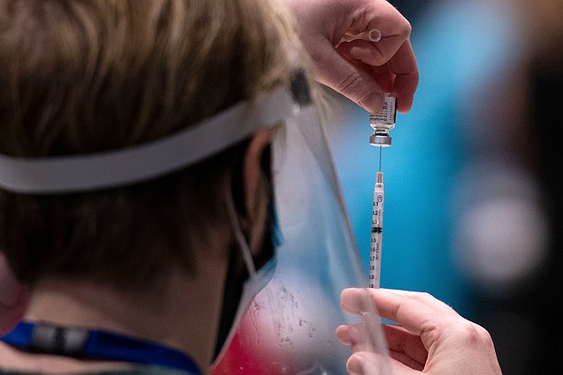 Erin Forsythe
Caption:	Virgina Mason advanced registered nurse practitioner Erin Forsythe loads a syringing with the Pfizer Covid-19 vaccine during a partnership with the hospital network and Amazon to increase the efficiency of vaccinations, at the Amazon Meeting Center in downtown Seattle, Washington on January 24, 2021.
Credit:	Grant Hindsley/AFP/Getty Images