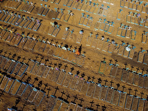 Aerial view showing a gravedigger standing at the Nossa Senhora Aparecida cemetery where COVID-19 victims are buried daily, in the neighbourhood of Taruma, in Manaus, Brazil.
Credit:	MICHAEL DANTAS/AFP/Getty Images