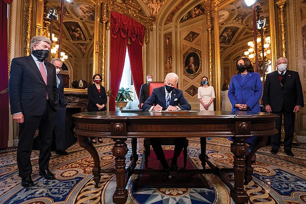 Shortly after the inaugural ceremony on Jan. 20, President Joe Biden gets to work signing documents in the President’s Room at the U.S. Capitol.