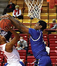 Davion Warren, right, blocks a shot for the Pirates.