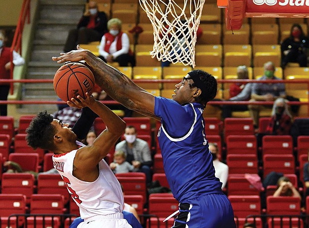 Davion Warren, right, blocks a shot for the Pirates.