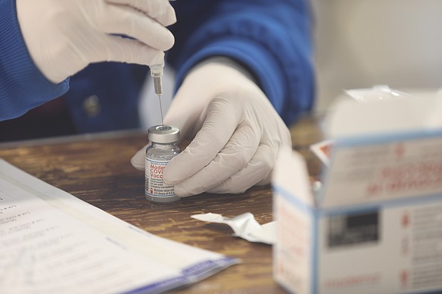 Terri Roe, a registered nurse with Henrico County Public Schools, fills syringes with the Moderna coronavirus vaccine Jan. 21 at the Old Dominion Building at the Richmond Raceway, where the Richmond and Henrico health districts are conducting mass inoculations.