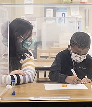 Pre-kindergarten teacher Sarah McCarthy works with a student at Dawes Elementary in Chicago, Monday, Jan. 11, 2021.
Credit:	Ashlee Rezin Garcia/Chicago Sun-Times/AP