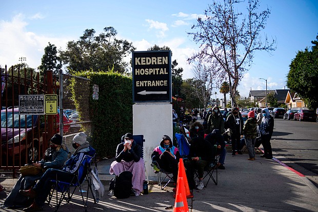 People without appointments wait in line for the potential chance to receive a Covid-19 vaccination that would have otherwise been discarded at the Kedren Community Health Center on January 25 in Los Angeles.
Credit:	Patrick T. Fallon/AFP/Getty Images