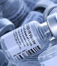 Empty vials of the Pfizer COVID-19 vaccine are seen at a first come first serve drive-thru vaccination site operated by the Lake County Health Department on January 28, 2021 in Groveland, Florida.
Credit:	Paul Hennessy/NurPhoto/Getty Images