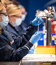 The Pfizer vaccine is prepared as the ballpark is opened as a COVID-19 Coronavirus pandemic public vaccination site on January 29, 2021 at Fenway Park in Boston, Massachusetts.
Credit:	Billie Weiss/Boston Red Sox/Getty Images